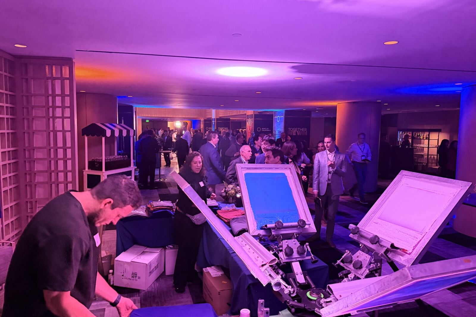 Live printing station drawing a crowd at an evening corporate reception
